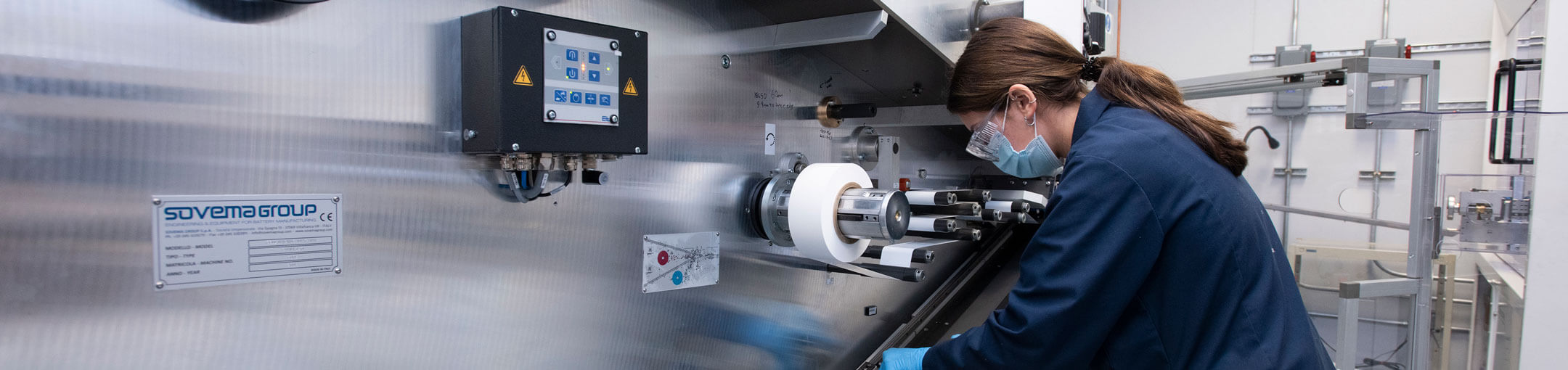 Eleni Ioannidis, a third - year chemical engineering student from Syracuse, NY, working with the cylindrical cell winder.