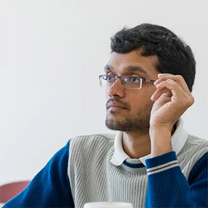 A male student sitting in a classroom.