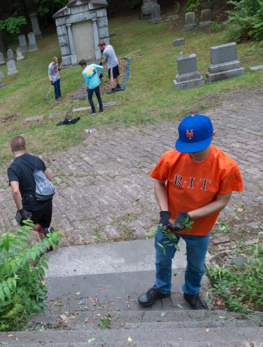 Students cleaning up a cemetary