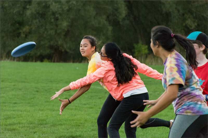 R I T students playing a game in a field.