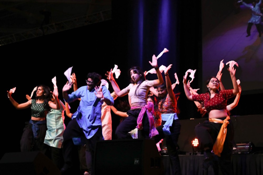 Members of RIT Zindagi do an Indian fusion dance on stage.